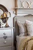 Romantic decor in silver and natural shades at head of country-house-style bed