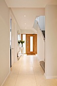 Light and bright, modern stairway and wooden front door