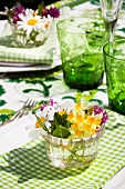Table decoration - small summer bouquets in a water glass