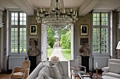 Crystal chandelier in grand living room with open garden doors