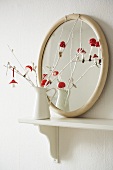 Decorative toadstools on a white painted twig in a vintage metal jug