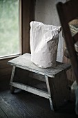 Paper bag on foot stool