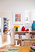 Storage baskets in wooden shelving unit in bright interior