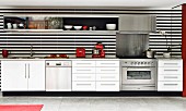 White, modern kitchen counter with black and white striped rear wall, mirrored wall at one end and red kitchen appliances