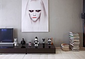 Black and white action figures below modern portrait of woman in Berlin artist's apartment
