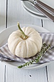 An autumnal place setting with an ornamental squash
