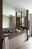 Grosse Spiegelfront in modernem Badezimmer mit zwei eingelassenen Waschbecken im Steinwaschtisch