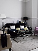 Sofa, rug, table lamps and small glass table in living room
