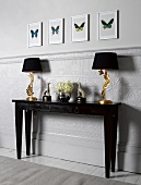 Lamps, vases and animal figurines on console table