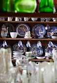 Classic blue and white china dinner service in open-fronted dresser