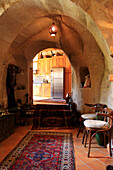 Interior of a cave dwelling with round arch passageway to the kitchen
