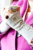 Grey wool felt wrist warmers decorated with star-patterned ribbon