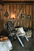Animal-skin rug on rustic wooden chair in wooden cabin