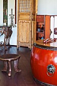 Large drum with metal fittings and ethnic, wooden stool