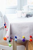 Tablecloth decorated with colourful pompoms