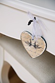 Heart-shaped pendant hanging from drawer key