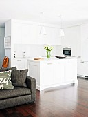 White, open-plan kitchen with island counter