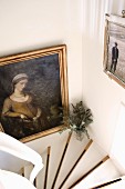Framed picture in stairwell; white stair treads with contrasting black edges