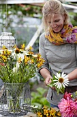 Woman arranging summery bouquet