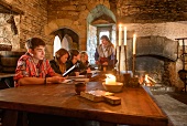 Pupils and a teacher in an old fortified castle