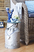 Dutch-style ornaments on milk churn converted into side table and wicker chair with scatter cushions