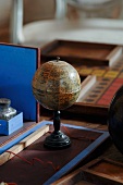 Stylised, vintage globe with stand on desk