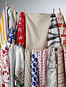 Colourful tea towels hanging on washing lines