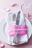 Cutlery on napkin decorated with ribbons & silver Cupid's arrow