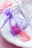 Sugared almonds in small satin bag as wedding favour