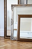 Framed mirrors on parquet floor