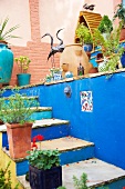 Original courtyard with colourful steps and potted plants