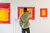 Man looking at pictures in an art gallery