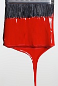 Still life of paint brush with red paint