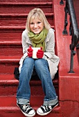 Woman drinking hot chocolate on front stoop