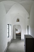 View from hallway into bedroom in former monastery; figure of Madonna in niche