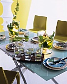 Set glass table with arrangements of plants in illuminated glass vases