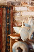 Vintage vase and dish on half-height cabinet in rustic setting