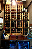 Wine rack made from wooden crates and bottle fridge
