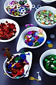 Dishes of various types of confetti for parties