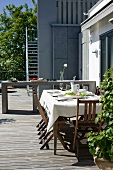 Set table on roof terrace with wooden decking