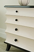 Black and white, post-modern chest of drawers with concave drawer fronts