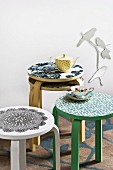 Wallpapered stools in front of a wall with decorative metal birds