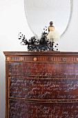 Ballerina figurine on antique chest of drawers with poem in English handwritten on front in white