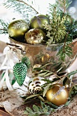 Christmas baubles and fir twigs in vintage copper bowl