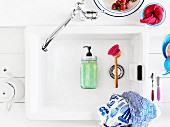 Soap dispenser hand-crafted from preserving jar lying in vintage sink