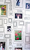 Souvenir photos arranged in picture frames of various sizes painted on interior wall
