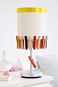 Lampshade decorated with clothes pegs