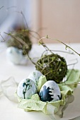 Four Easter eggs painted in natural colours