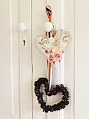 A heart-shaped decorating hanging from a doorknob