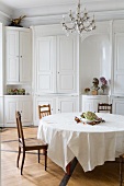 White dining room with a round table in a former monastery
